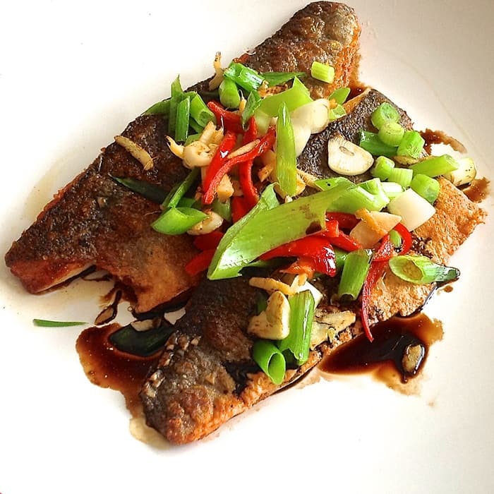 Sea bass with sizzled ginger, chilli & spring onions